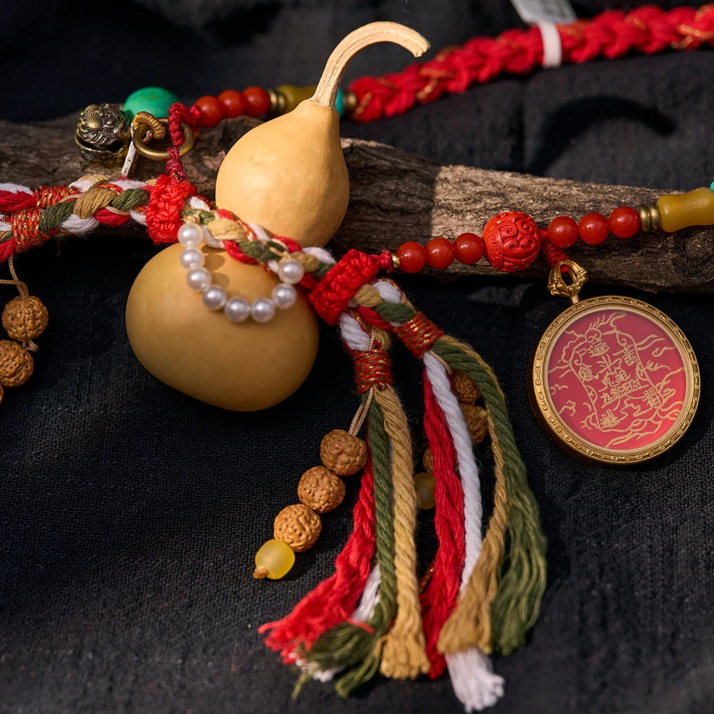 Handcrafted Himalayan amulet with gourd, pearls, prayer beads, and multicolor tassels