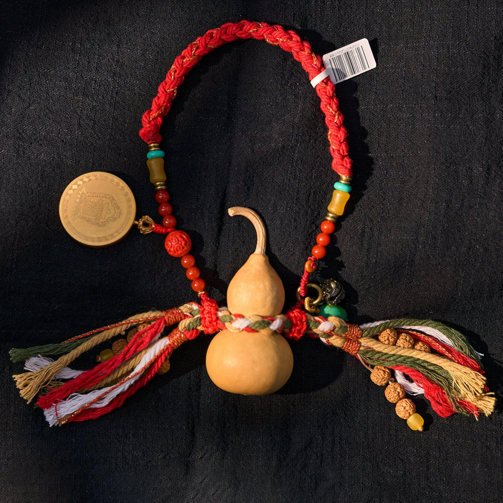 Tibetan style woven amulet necklace with gourd charm, colorful threads, beads, and coin accent