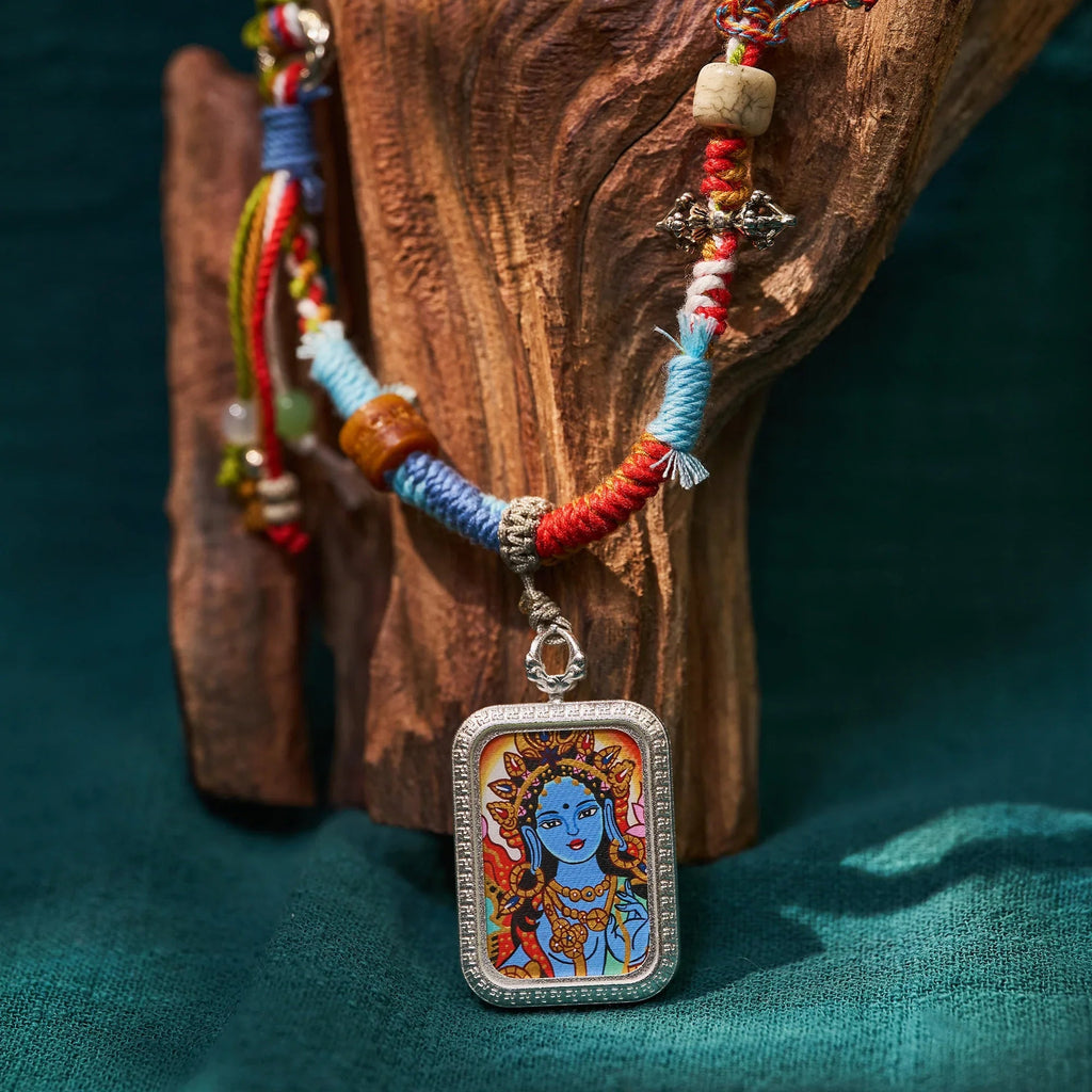 Handcrafted Himalayan necklace with colorful woven cord and painted deity pendant