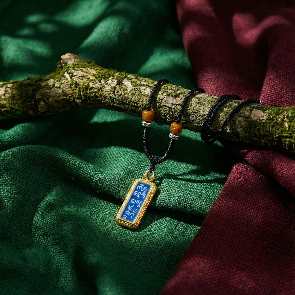 Tibetan Buddhist amulet necklace with blue and gold pendant on mossy branch, meditation jewelry